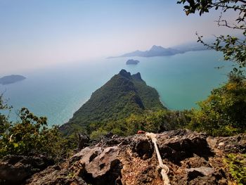 Scenic view of sea and mountains against sky