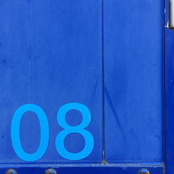 Close-up of text on blue wall