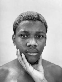 Close-up portrait of young man against white background