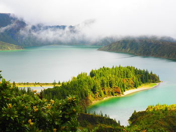 Scenic view of lake and mountains against sky