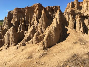 Low angle view of rock formation against sky