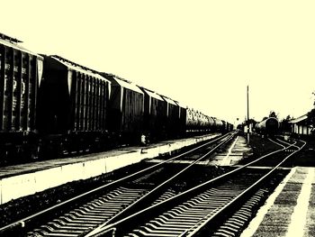 Train at railroad station against clear sky