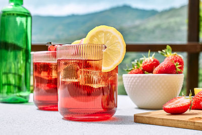 Fresh summer strawberry cocktail or mocktail on the table in the garden. 