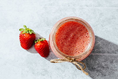 Strawberries on glass against white background