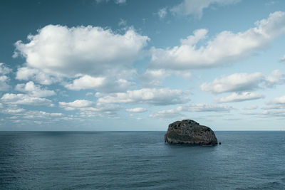 Scenic view of a rock in the sea against sky
