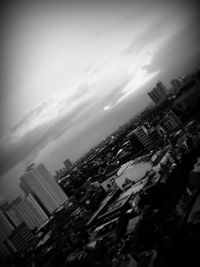 Skyscrapers against cloudy sky