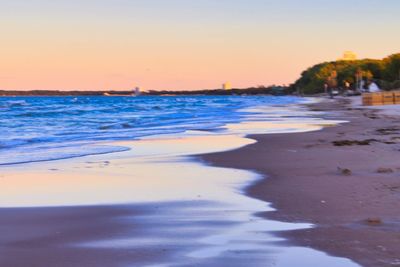 Scenic view of beach against sky during sunset