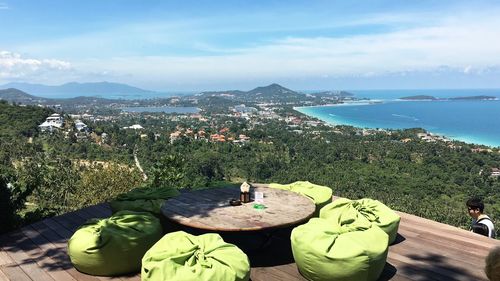 Scenic view of sea by mountains against sky