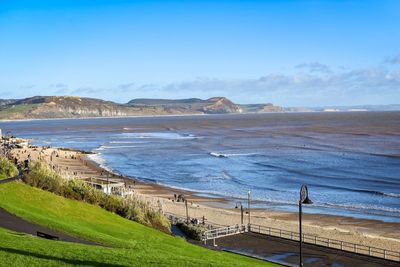 Scenic view of beach against clear blue sky