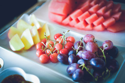 High angle view of chopped fruits in plate on table