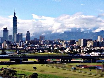 City skyline against cloudy sky