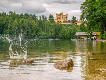 Scenic view of lake by trees against sky