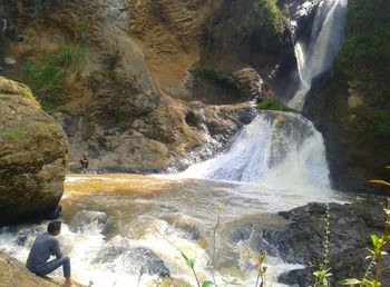 Scenic view of river flowing through rocks