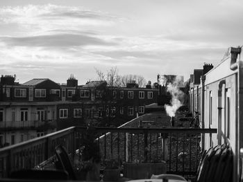 Buildings against cloudy sky