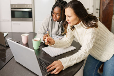 Young women using laptop working at home