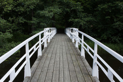 Footbridge against trees