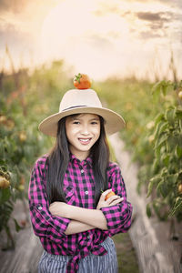 Portrait of smiling girl standing against plants