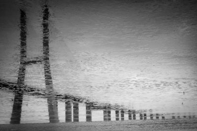 Reflection of built structure in puddle