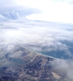 Aerial view of volcanic landscape against cloudy sky