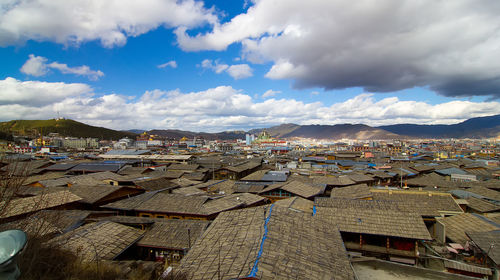 High angle view of townscape against cloudy sky