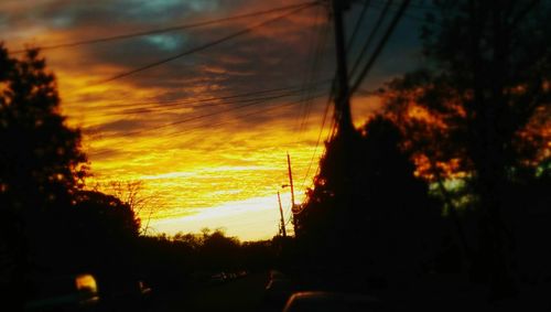 Silhouette of power lines at sunset