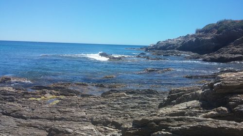 Scenic view of sea against clear blue sky