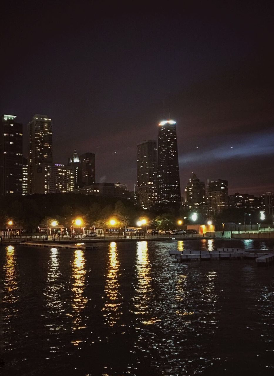 VIEW OF ILLUMINATED CITY AT NIGHT