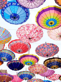 Low angle view of colorful umbrellas against sky