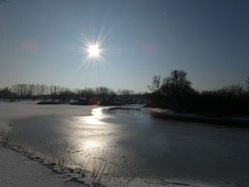 Scenic view of frozen lake against sky during winter