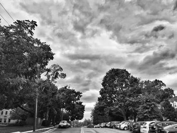 Road amidst trees against sky