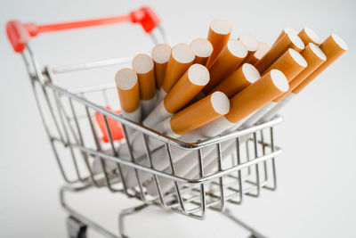 Close-up of shopping cart on white background