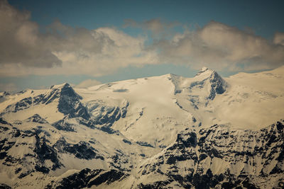 Scenic view of snow covered mountains against sky