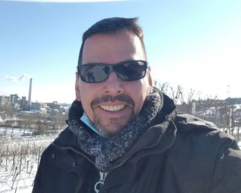 Portrait of smiling man in snow