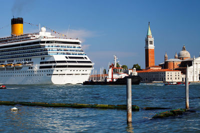 Cruise ship on sea with st mark square against blue sky