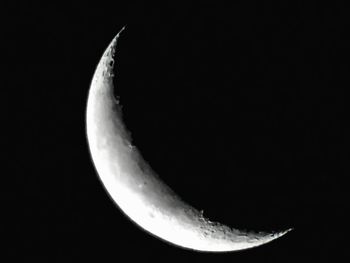 Low angle view of half moon against sky at night