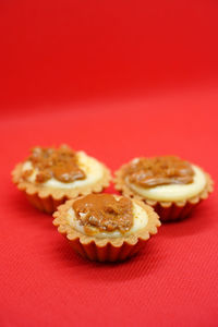 Close-up of cupcake against red background