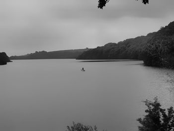 Scenic view of lake against cloudy sky