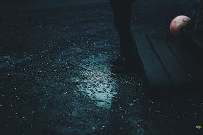 Low section of woman walking on road