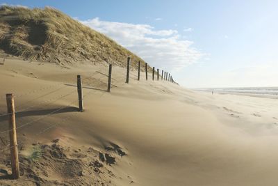 Fence on sand at beach
