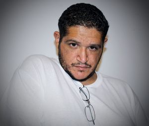 Portrait of mid adult man sitting against white background