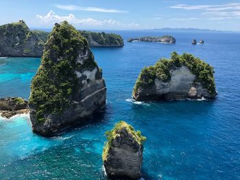 Scenic view of rocks in sea against sky