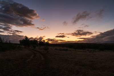 Scenic view of field against sky during sunset