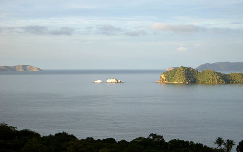 Scenic view of calm sea against cloudy sky