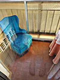 Low section of man relaxing on chair at home