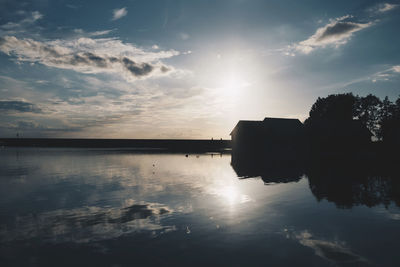 Scenic view of lake with reflection against sky on sunny day