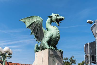 Low angle view of statue against blue sky