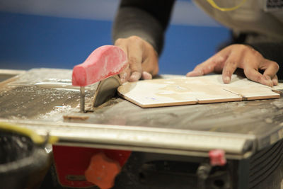 Close-up of person working in tray