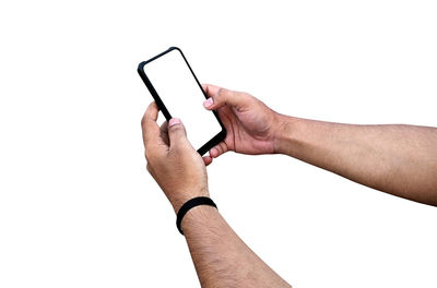 Low section of man using smart phone against white background