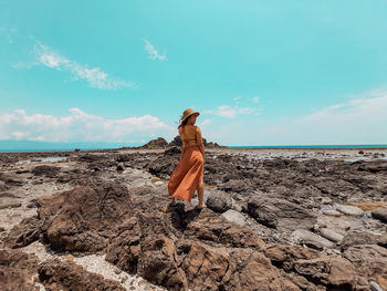 Woman on beach against sky