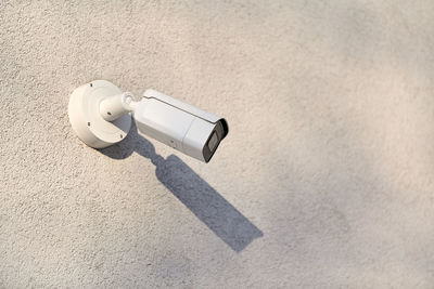 High angle view of camera on white wall